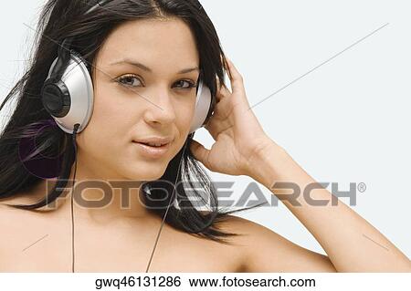 Portrait of a young woman wearing headphones and listening to music View Large Photo Image Stock Photograph - Portrait of a young woman wearing headphones and listening to music. Fotosearch