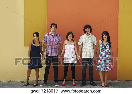 Stock Photo - Portrait of two young men and three young women standing with holding their hands, Puerto Rico. Fotosearch