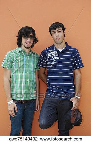 Portrait of two young men standing together View Large Photo Image Stock Image - Portrait of two young men standing together. Fotosearch