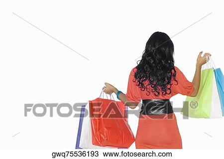 Rear view of a teenage girl holding shopping bags View Large Photo Image Stock Image - Rear view of a teenage girl holding shopping bags. Fotosearch
