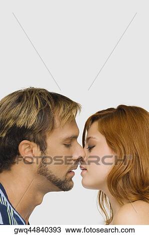Side profile of a couple kissing each other View Large Photo Image Stock Image - Side profile of a couple kissing each other. Fotosearch