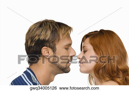 Side profile of a couple kissing each other View Large Photo Image Stock Photograph - Side profile of a couple kissing each other. Fotosearch
