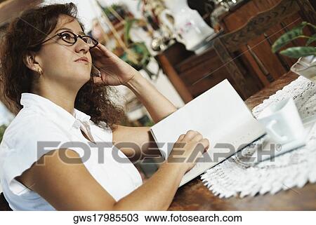 Side profile of a mature woman reading a book and thinking View Large Photo Image Stock Image - Side profile of a mature woman reading a book and thinking. Fotosearch