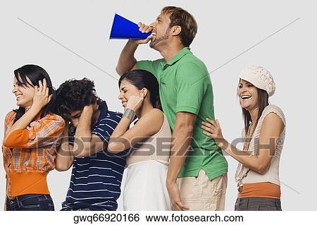 Side profile of a mid adult man shouting into a megaphone between his friends View Large Photo Image Stock Photograph - Side profile of a mid adult man shouting into a megaphone between his friends. Fotosearch