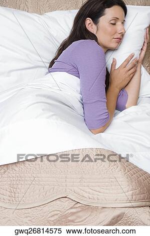 Side profile of a mid adult woman sleeping on the bed View Large Photo Image Stock Photography - Side profile of a mid adult woman sleeping on the bed. Fotosearch