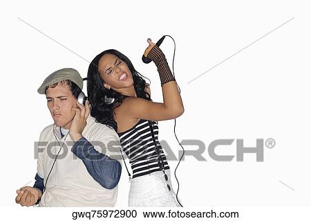 Side profile of a teenage girl singing and a young man listening to music View Large Photo Image Stock Image - Side profile of a teenage girl singing and a young man listening to music. Fotosearch