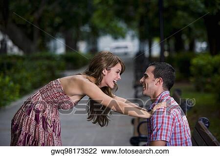 Side profile of a young couple looking at each other and smiling View Large Photo Image Stock Image - Side profile of a young couple looking at each other and smiling. Fotosearch