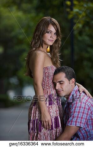 Side profile of a young couple romancing in a park View Large Photo Image Picture - Side profile of a young couple romancing in a park. Fotosearch