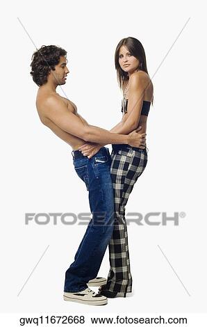 Side profile of a young couple standing together View Large Photo Image Stock Photo - Side profile of a young couple standing together. Fotosearch
