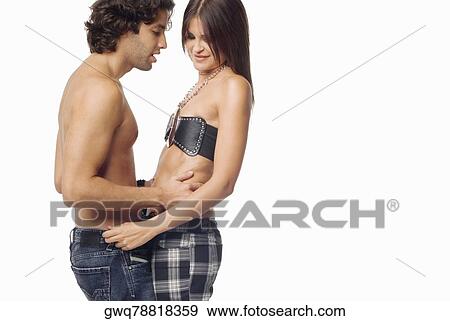 Side profile of a young couple standing together and smiling View Large Photo Image Stock Photo - Side profile of a young couple standing together and smiling. Fotosearch