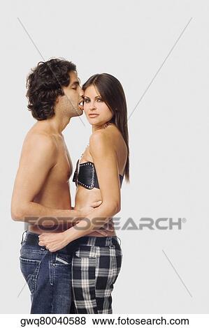 Side profile of a young man kissing a young woman View Large Photo Image Stock Photo - Side profile of a young man kissing a young woman. Fotosearch