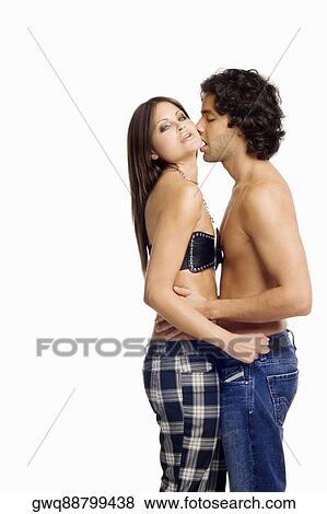 Stock Photo - Side profile of a young man kissing a young woman. Fotosearch