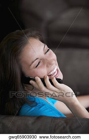 Side profile of a young woman talking on a mobile phone View Large Photo Image Stock Image - Side profile of a young woman talking on a mobile phone. Fotosearch