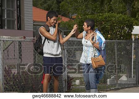 Teenage boy and his sister sharing an ipod View Large Photo Image Stock Image - Teenage boy and his sister sharing an ipod. Fotosearch