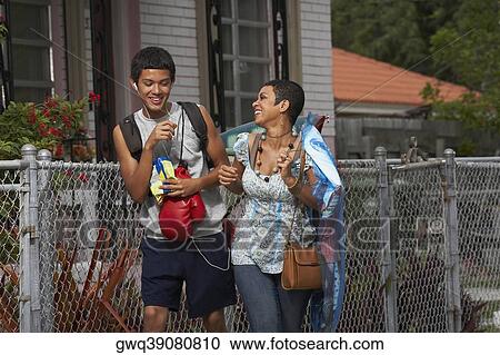 Teenage boy and his sister walking and smiling View Large Photo Image Stock Image - Teenage boy and his sister walking and smiling. Fotosearch