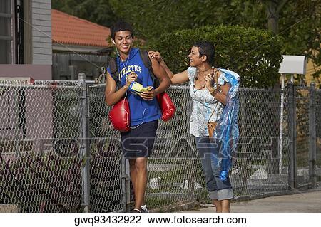 Teenage boy and his sister walking on the walkway View Large Photo Image Stock Image - Teenage boy and his sister walking on the walkway. Fotosearch