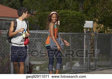 Teenage boy flirting with a young woman View Large Photo Image Stock Image - Teenage boy flirting with a young woman. Fotosearch