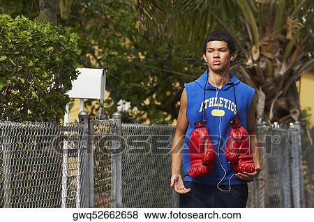 Stock Photo - Teenage boy listening an ipod and walking. Fotosearch