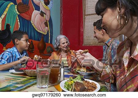 Three generation family taking food in a restaurant View Large Photo Image Stock Image - Three generation family taking food in a restaurant. Fotosearch