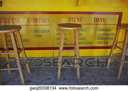 Three wooden stools at a juice bar View Large Photo Image Picture - Three wooden stools at a juice bar. Fotosearch