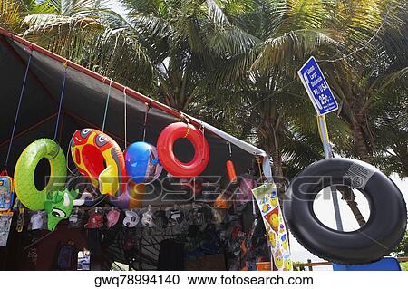 Stock Image - Toys hanging in a store on the beach, Pinones Beach, Puerto Rico. Fotosearch
