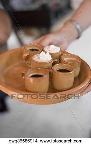 Woman carrying tray of coffee View Large Photo Image Picture - Woman carrying tray of coffee. Fotosearch