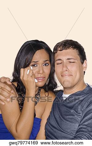 Young man and a teenage girl watching television and crying View Large Photo Image Stock Photo - Young man and a teenage girl watching television and crying. Fotosearch