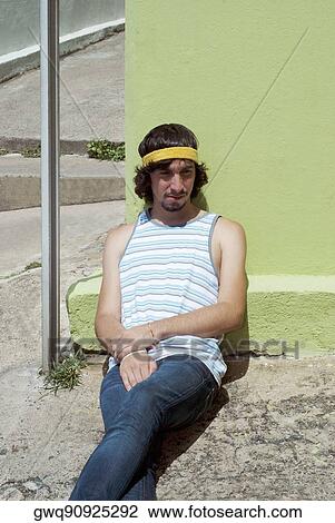 Young man leaning against a wall and thinking View Large Photo Image Stock Image - Young man leaning against a wall and thinking. Fotosearch