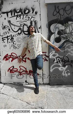 Stock Photograph - Young man leaning against a wall and thinking. Fotosearch