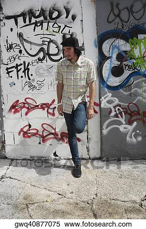 Stock Photography - Young man leaning against a wall. Fotosearch