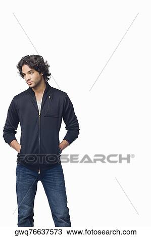 Young man standing with his hands in his pockets View Large Photo Image Stock Image - Young man standing with his hands in his pockets. Fotosearch