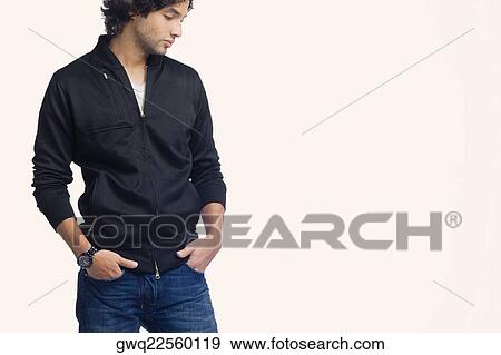 Young man standing with his hands in his pockets View Large Photo Image Stock Photo - Young man standing with his hands in his pockets. Fotosearch