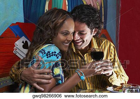 Young man toasting wine with a young woman in a restaurant View Large Photo Image Stock Photograph - Young man toasting wine with a young woman in a restaurant. Fotosearch