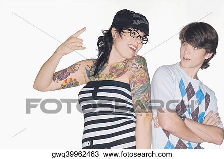 Young woman gesturing with a teenage boy standing beside her View Large Photo Image Stock Image - Young woman gesturing with a teenage boy standing beside her. Fotosearch