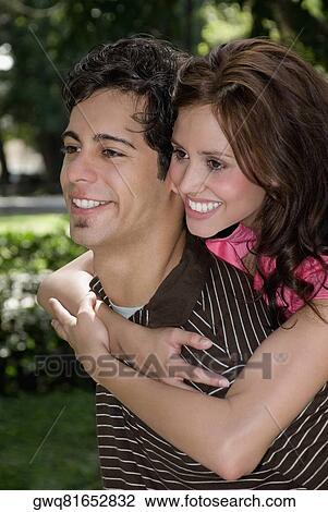 Young woman riding piggyback on a young man View Large Photo Image Stock Image - Young woman riding piggyback on a young man. Fotosearch