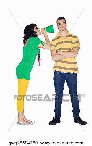 Young woman shouting with a megaphone into a young man's ear View Large Photo Image Stock Image - Young woman shouting with a megaphone into a young man's ear. Fotosearch
