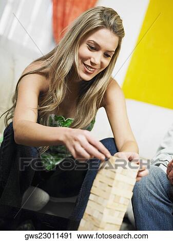 Young woman stacking blocks on top of each other View Large Photo Image Stock Image - Young woman stacking blocks on top of each other. Fotosearch