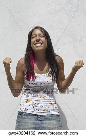 Young woman standing with her eyes closed and smiling View Large Photo Image Stock Image - Young woman standing with her eyes closed and smiling. Fotosearch