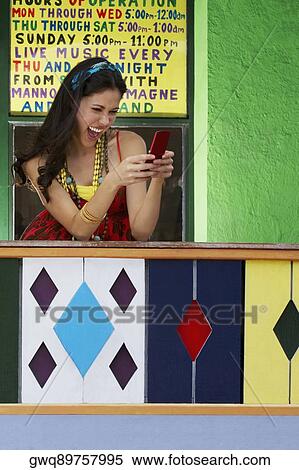Young woman text messaging on a mobile phone View Large Photo Image Stock Photography - Young woman text messaging on a mobile phone. Fotosearch