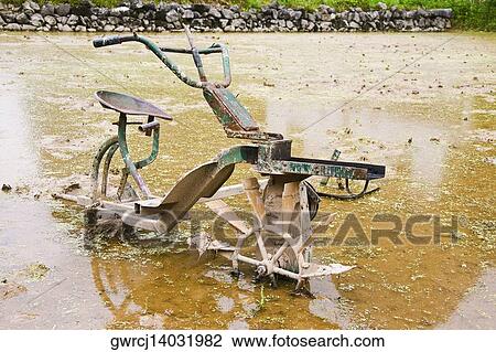 Stock Image - Agricultural equipment in a field, XingPing, Yangshuo, Guangxi Province, China. Fotosearch