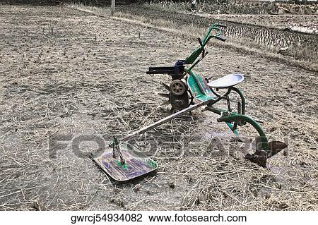Stock Image - Agricultural equipment in a rice field, Li River, XingPing, Yangshuo, Guangxi Province, China. Fotosearch