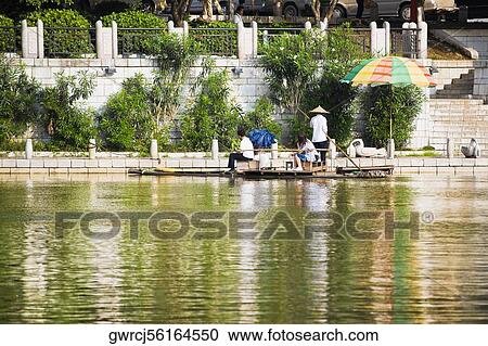 Stock Image - Bamboo raft in a river, Guilin, Guangxi Province, China. Fotosearch