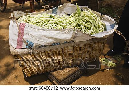 Stock Image - Beans in a basket at a market stall, Zhigou, Shandong Province, China. Fotosearch