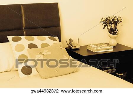 Bed and a side table in a bedroom View Large Photo Image Stock Image - Bed and a side table in a bedroom. Fotosearch