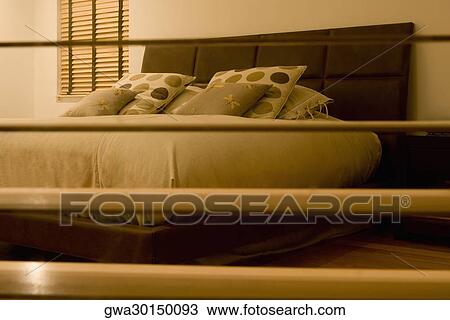 Stock Image - Bedroom viewed through a window. Fotosearch