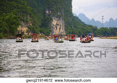 Boats in a river with a hill range in the background, Guilin Hills, XingPing, Yangshuo, Guangxi Province, China View Large Photo Image Stock Image - Boats in a river with a hill range in the background, Guilin Hills, XingPing, Yangshuo, Guangxi Province, China. Fotosearch
