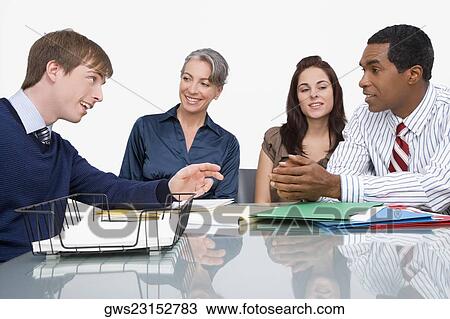 Stock Image - Business executives at a meeting in an office. Fotosearch