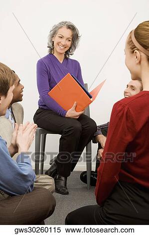 Stock Photography - Business executives at a meeting in an office. Fotosearch