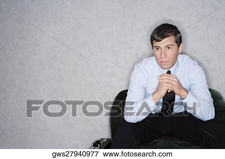 Businessman sitting in an armchair and thinking View Large Photo Image Stock Photo - Businessman sitting in an armchair and thinking. Fotosearch