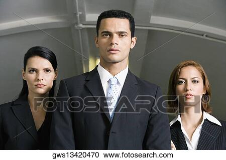 Businessman standing with two businesswomen in a subway View Large Photo Image Stock Image - Businessman standing with two businesswomen in a subway. Fotosearch